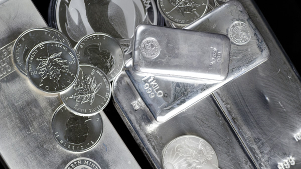 Image: A collection of silver bars and coins.